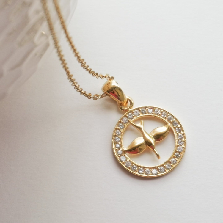 Holy Spirit pendant has gold over sterling silver and surrounded by a circle of cubic zirconia stones