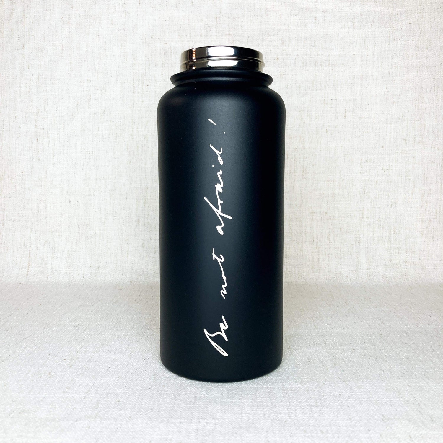 Black stainless steel powder coated water bottle with phrase "Be not afraid" engraved in the handwriting of John Paul II